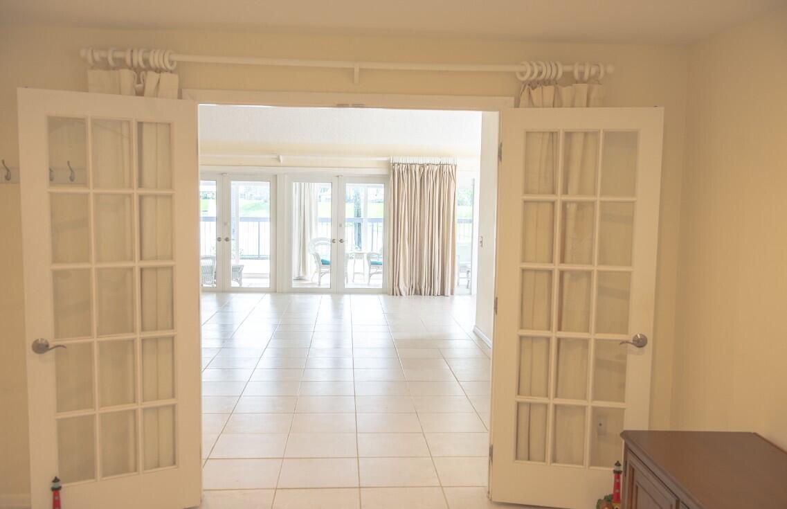 114 Beach Summit Court Jupiter, FL 33477 - Photo 25 of 32 a view of a bathroom with a glass door shower and a window
