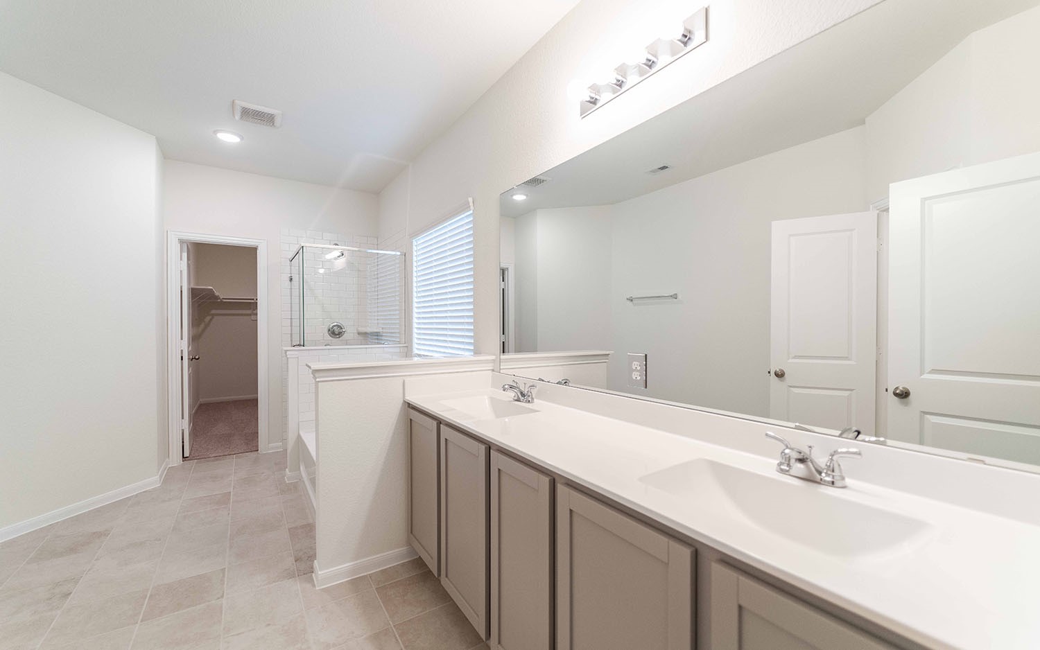 10604 Altitude Way Conroe, TX 77303 - Photo 13 of 33 a bathroom with a sink double vanity and a mirror
