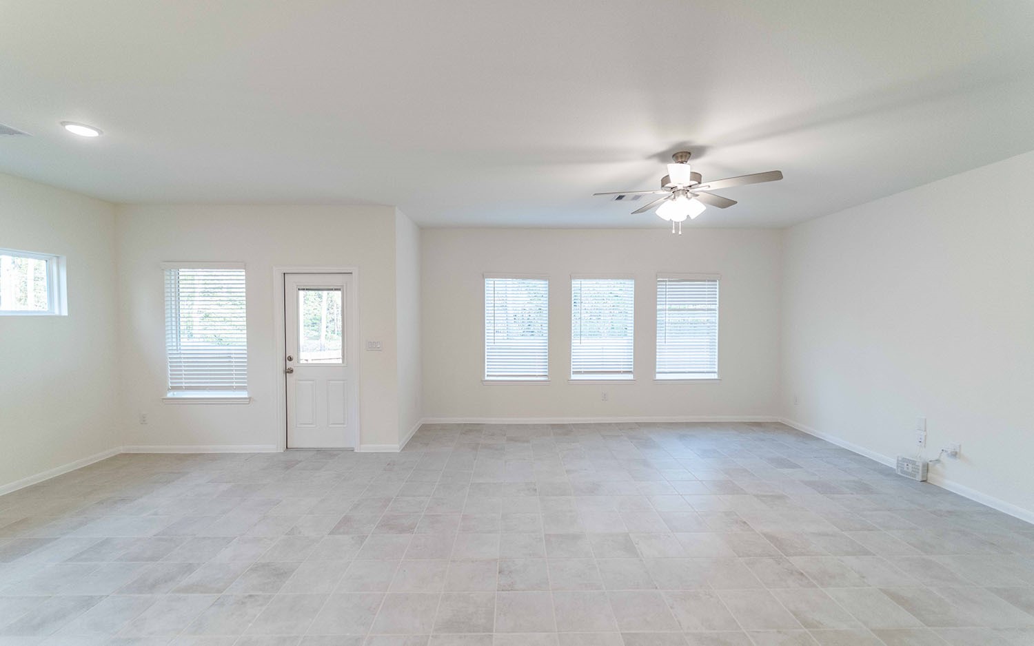 10604 Altitude Way Conroe, TX 77303 - Photo 3 of 33 an empty room with chandelier fan and windows