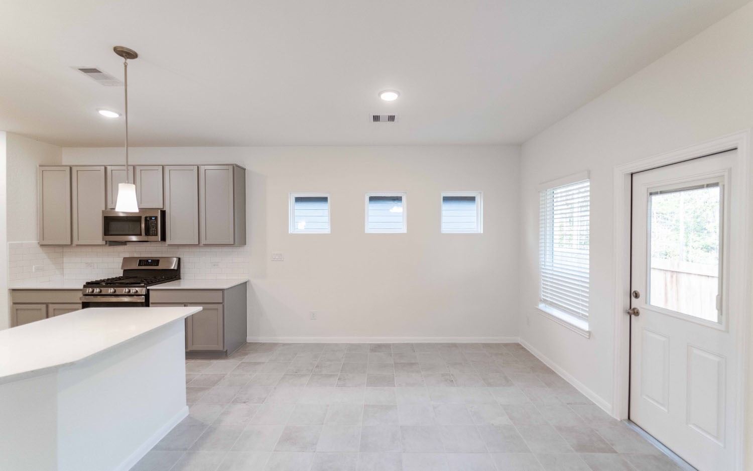 10604 Altitude Way Conroe, TX 77303 - Photo 4 of 33 a kitchen with stainless steel appliances a stove top oven a sink a refrigerator and cabinets