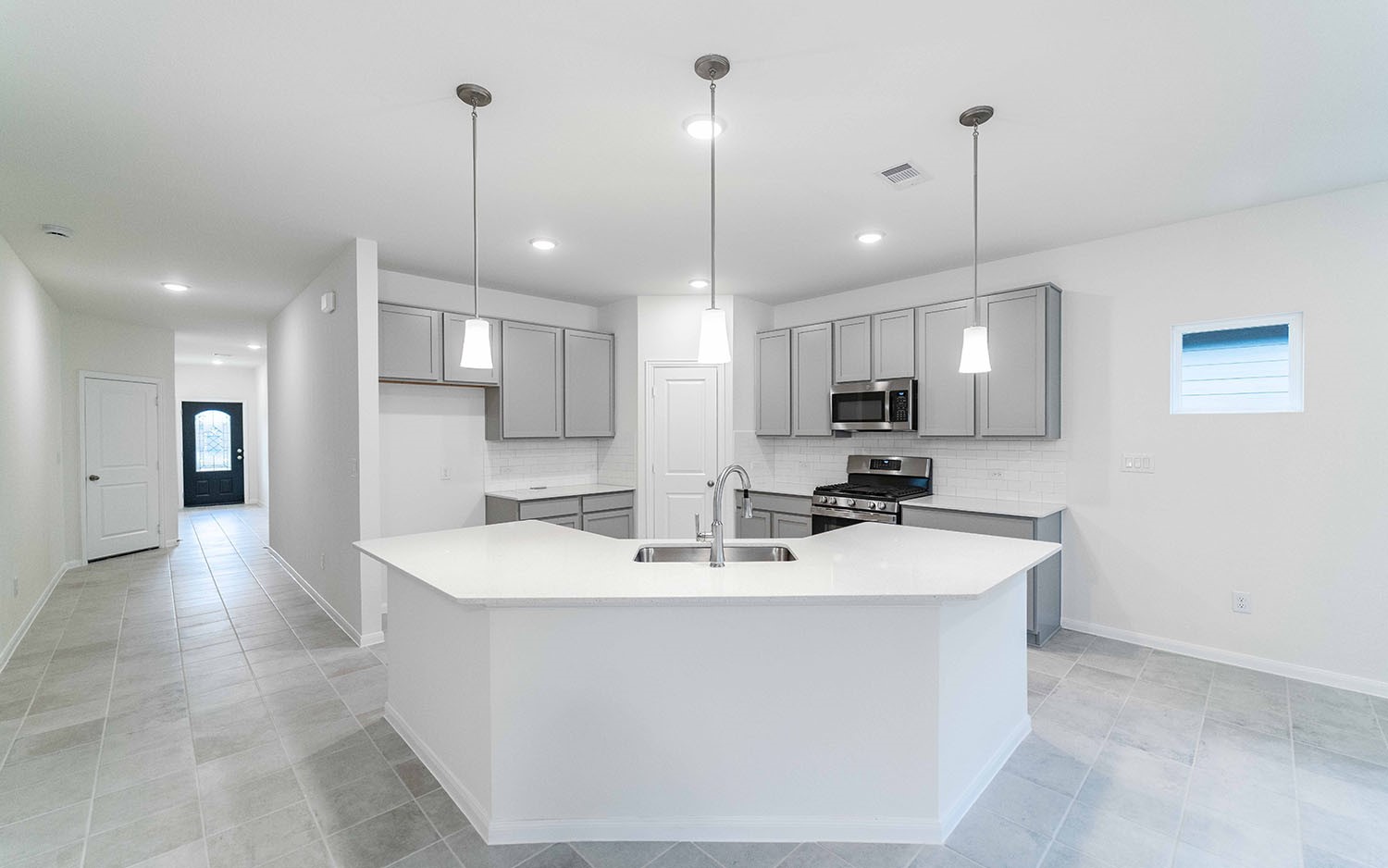 10604 Altitude Way Conroe, TX 77303 - Photo 8 of 33 a large kitchen with kitchen island a sink stainless steel appliances and cabinets
