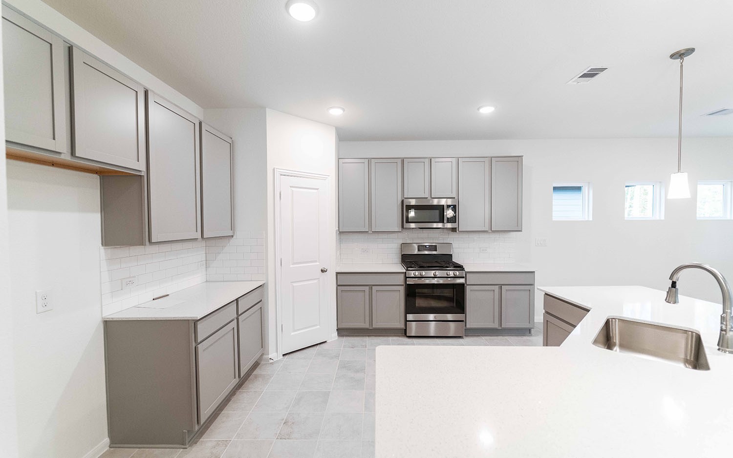 10604 Altitude Way Conroe, TX 77303 - Photo 9 of 33 a kitchen with stainless steel appliances granite countertop a sink stove and refrigerator