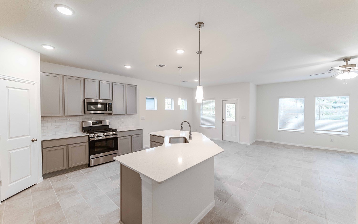 10604 Altitude Way Conroe, TX 77303 - Photo 10 of 33 a kitchen with granite countertop a sink a counter space appliances and cabinets