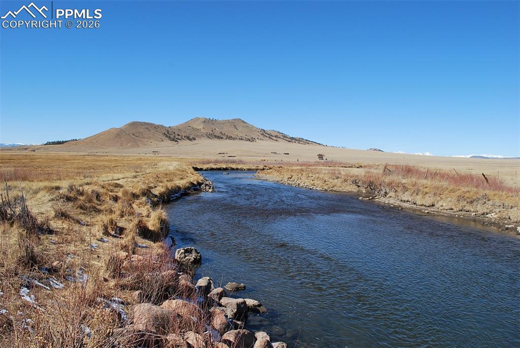 1198 Chase Gulch Road Hartsel, CO 80449 - Photo 16 of 16 a view of an ocean with a mountain in the background