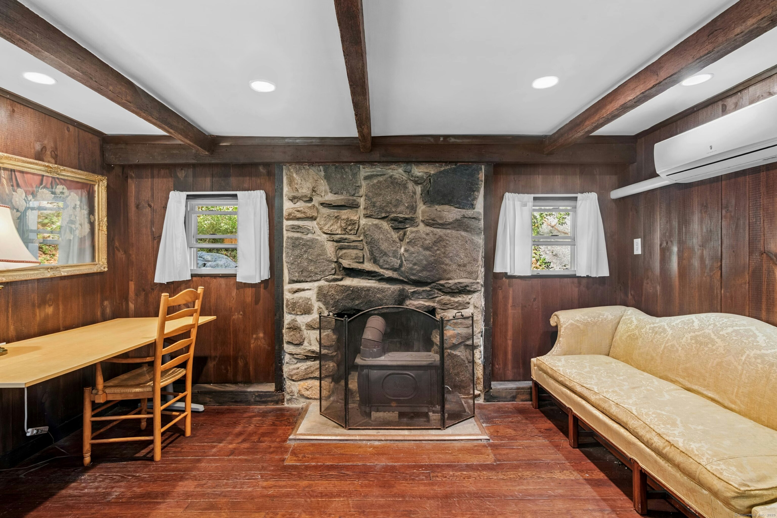 492 Newtown Turnpike Weston, CT 06883 - Photo 3 of 10 a living room with furniture a fireplace and a floor to ceiling window