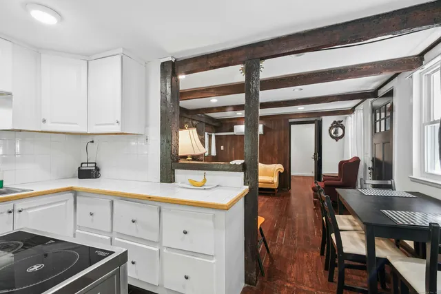 a kitchen with a refrigerator and white cabinets