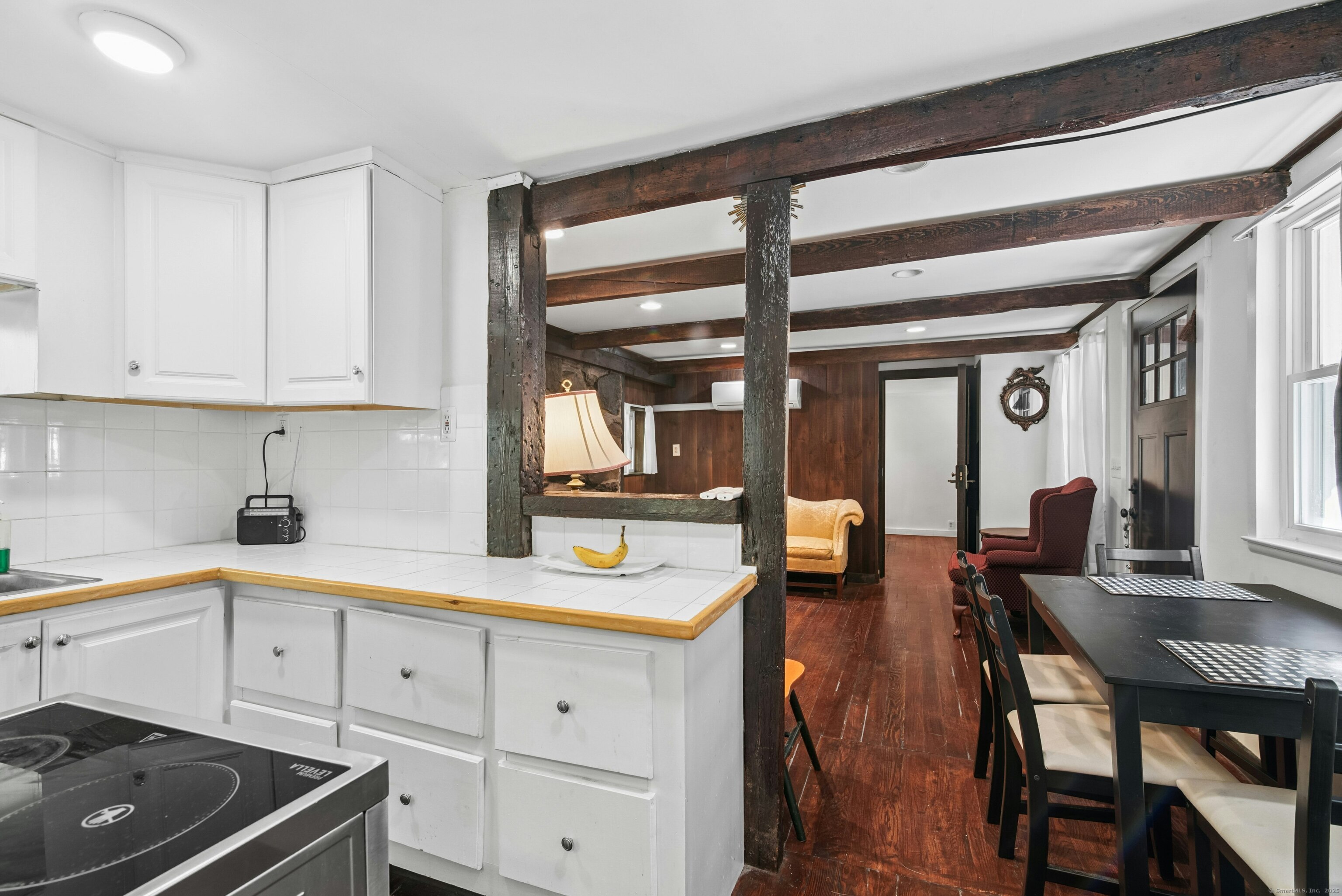 492 Newtown Turnpike Weston, CT 06883 - Photo 6 of 10 a kitchen with a refrigerator and white cabinets