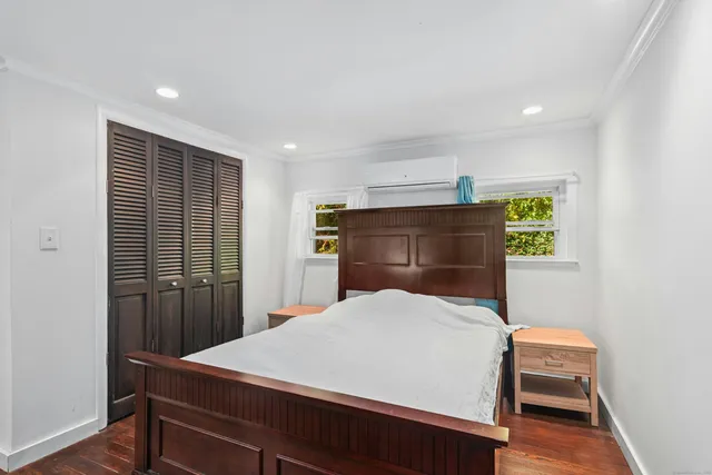 a bedroom with a bed and a dresser