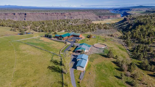 an aerial view of a house with outdoor space