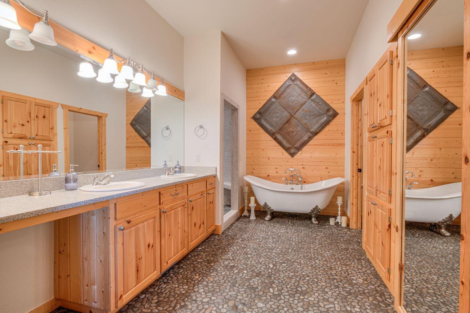 10000 Southwest Lyons Drive Culver, OR 97734 - Photo 30 of 90 a spacious bathroom with a double vanity sink and a large mirror