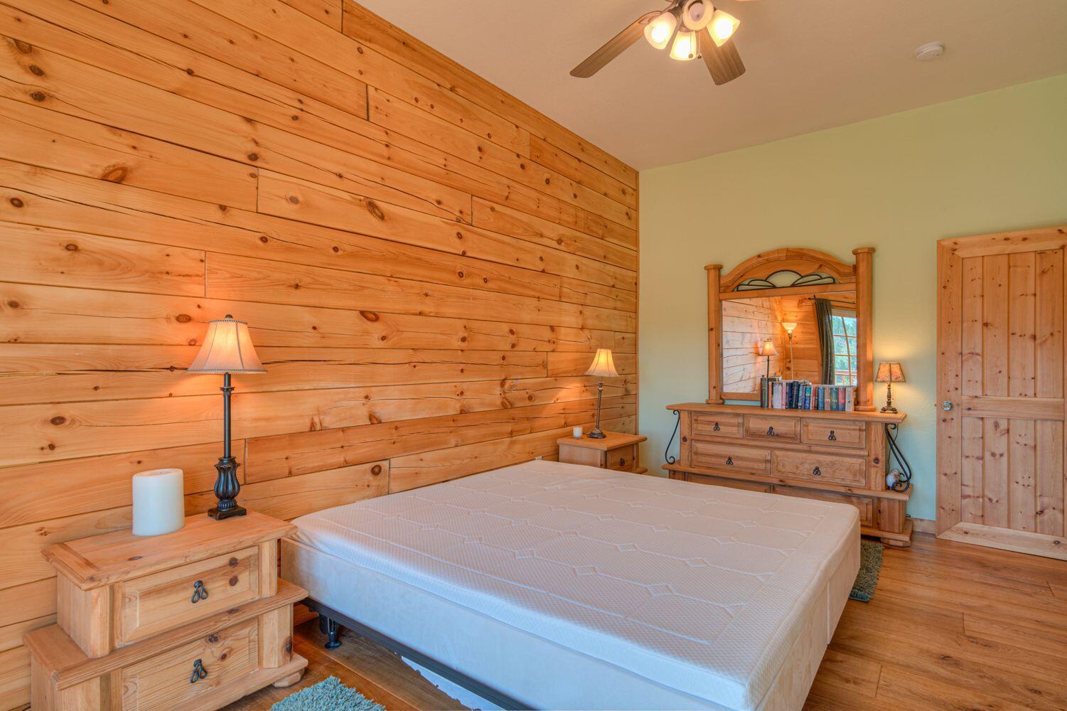 10000 Southwest Lyons Drive Culver, OR 97734 - Photo 34 of 90 a bedroom with a bed and a chandelier