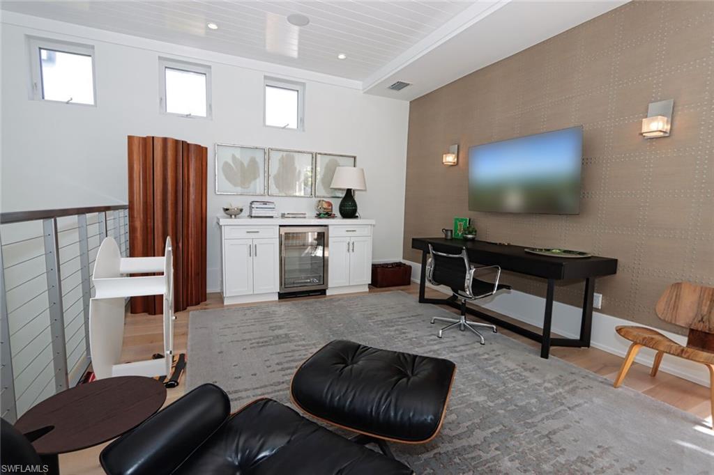 675 2nd Street South Naples, FL 34102 - Photo 10 of 41 a living room with furniture and a flat screen tv
