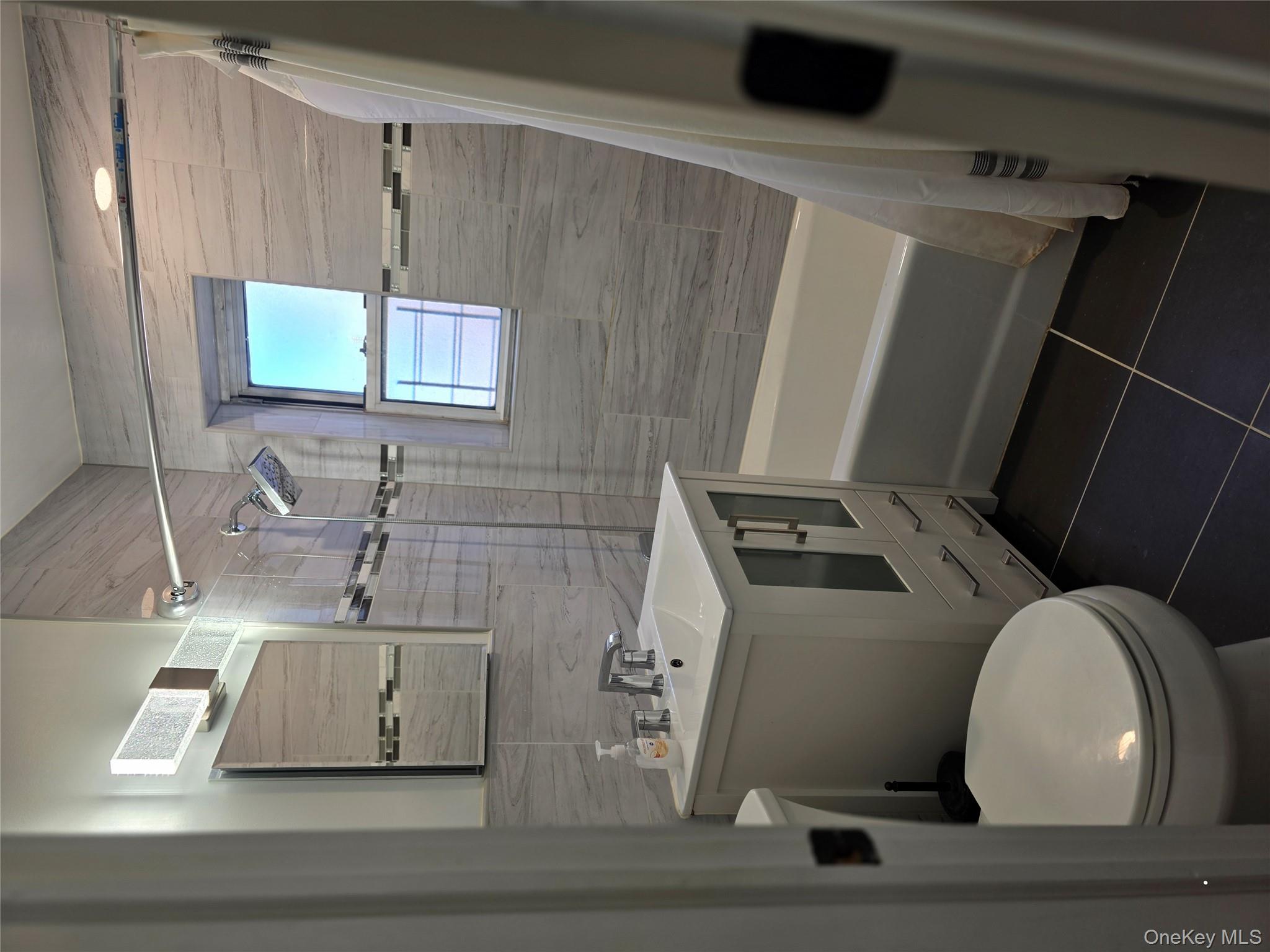 70 Locust Avenue, Unit B505 New Rochelle, NY 10801 - Photo 11 of 14 a bathroom with a sink toilet and shower