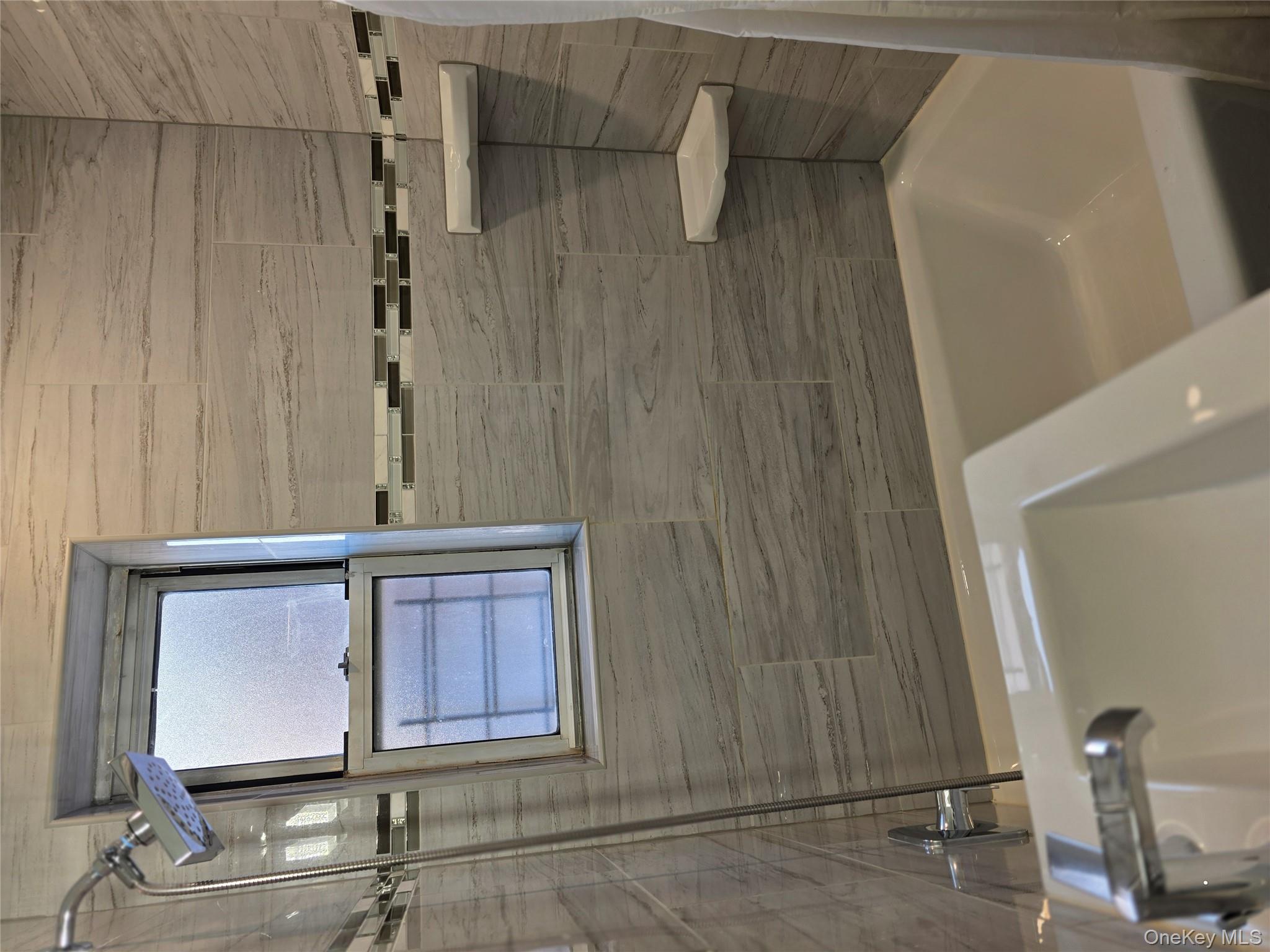 70 Locust Avenue, Unit B505 New Rochelle, NY 10801 - Photo 12 of 14 a bathroom with a tub