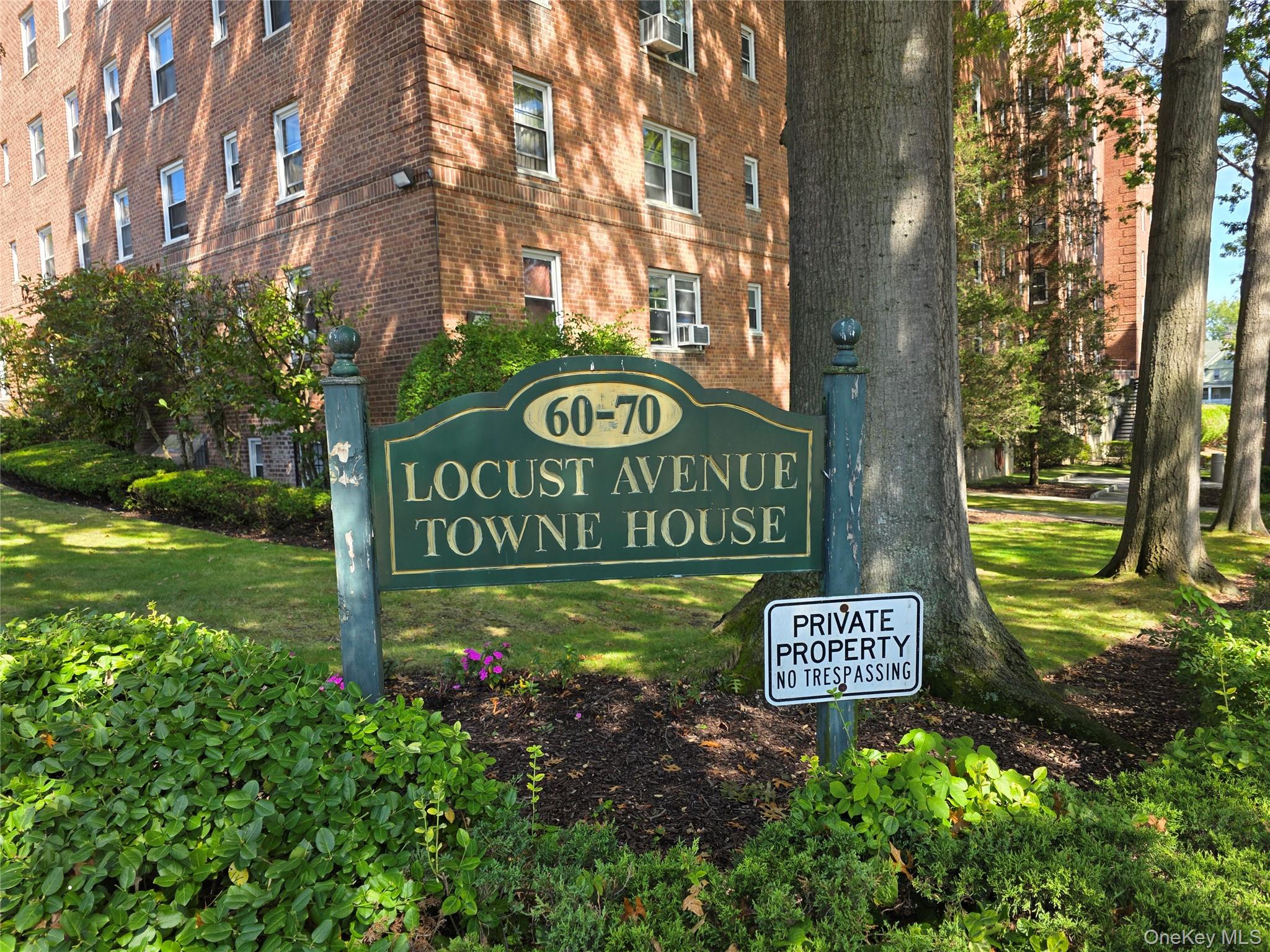70 Locust Avenue, Unit B505 New Rochelle, NY 10801 - Photo 2 of 14 a sign that is sitting in front of flowers
