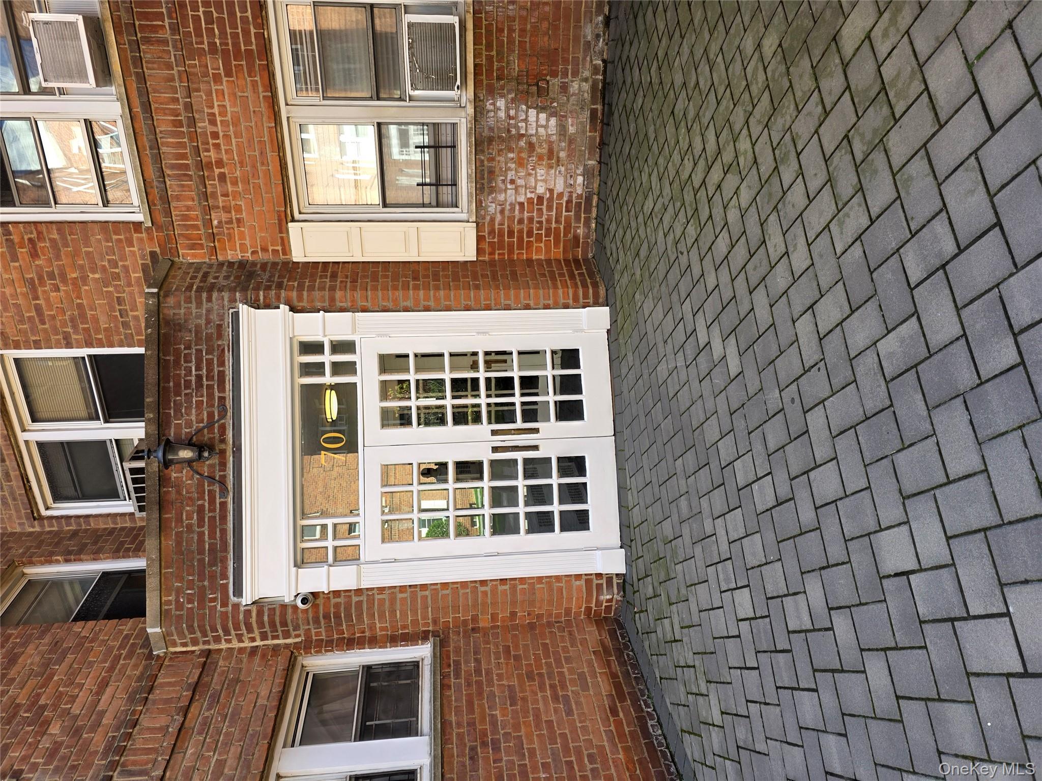 70 Locust Avenue, Unit B505 New Rochelle, NY 10801 - Photo 3 of 14 a front view of a house with a large window