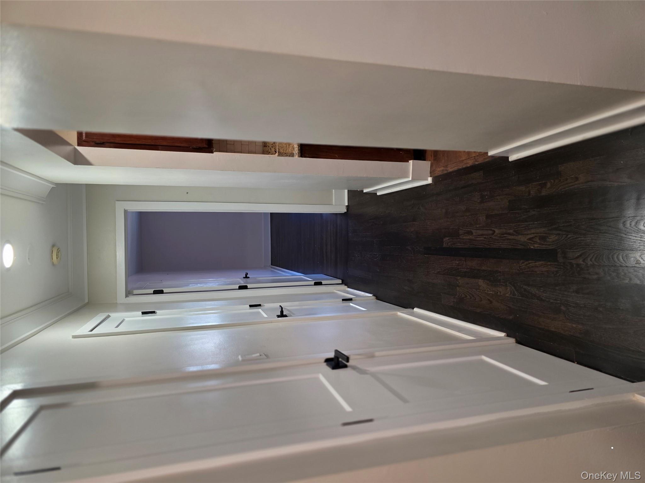 70 Locust Avenue, Unit B505 New Rochelle, NY 10801 - Photo 5 of 14 a view of a hallway with wooden floor and staircase