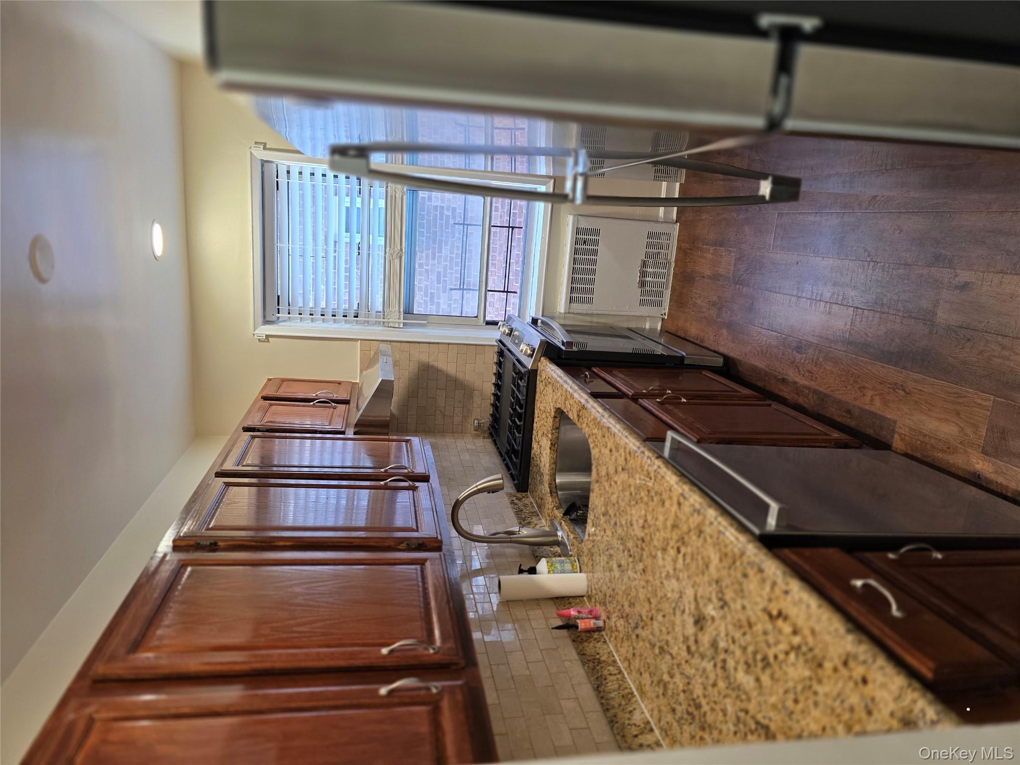 70 Locust Avenue, Unit B505 New Rochelle, NY 10801 - Photo 8 of 14 a kitchen with stainless steel appliances granite countertop a stove a sink and a refrigerator