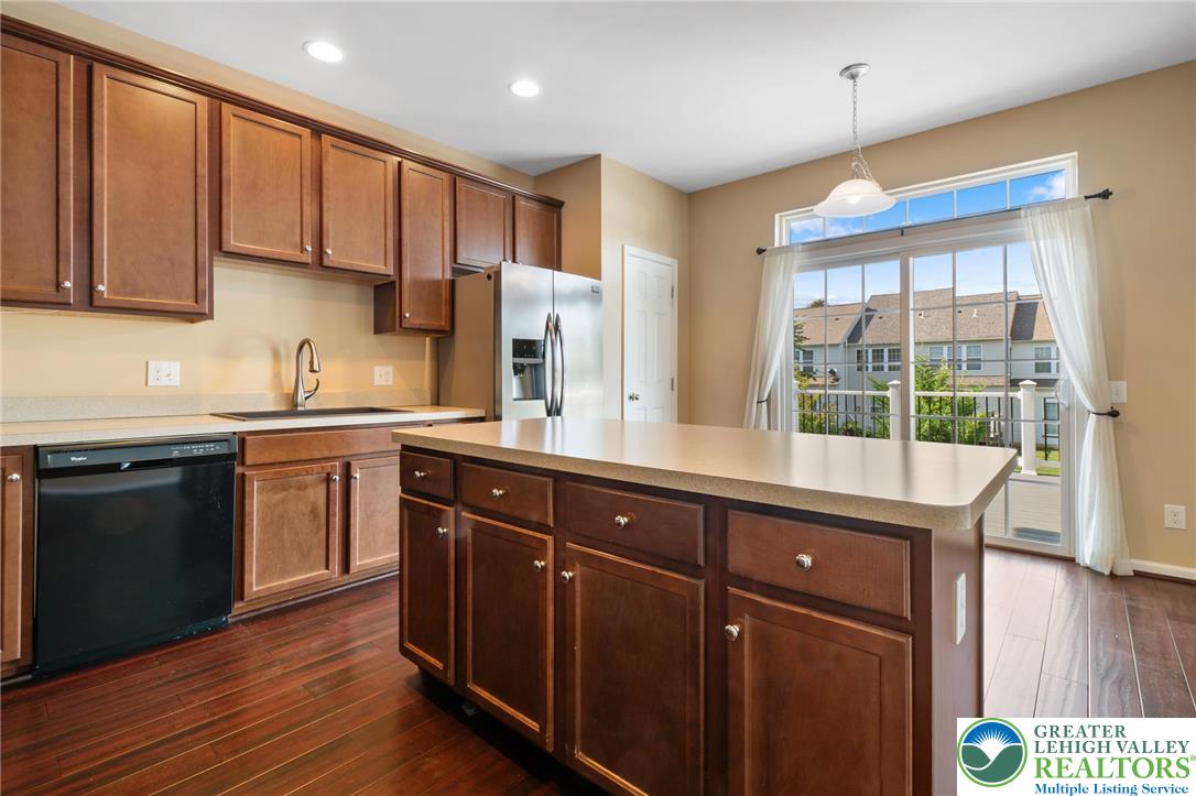 8455 Starling Road Breinigsville, PA 18031 - Photo 6 of 24 A contemporary kitchen features rich cabinetry, stainless steel appliances, and a central island.
