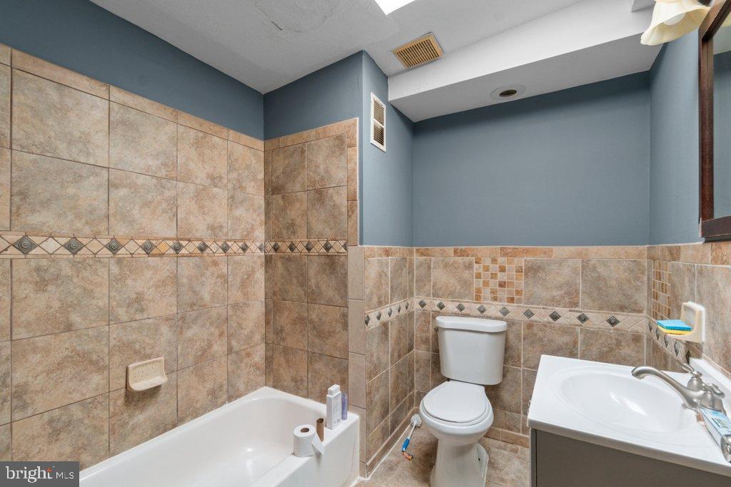 1309 Kuper Place Baltimore, MD 21223 - Photo 15 of 20 a bathroom with a sink a toilet and shower