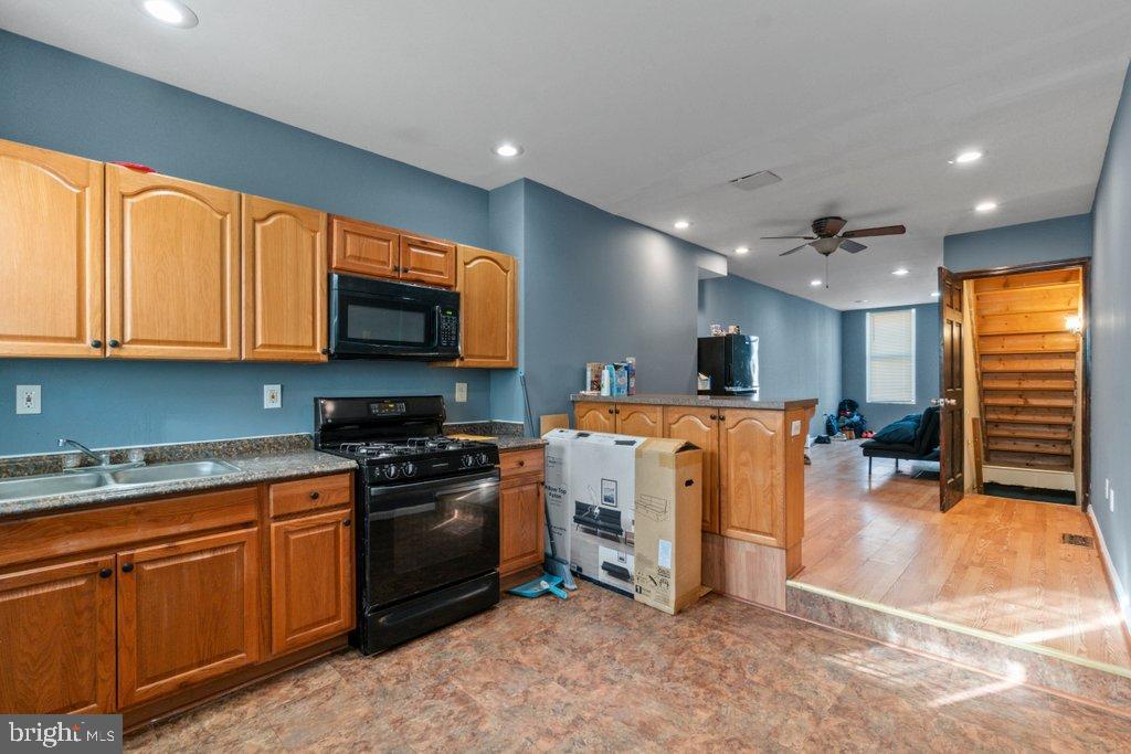 1309 Kuper Place Baltimore, MD 21223 - Photo 9 of 20 a view of kitchen with stainless steel appliances granite countertop sink stove top oven and cabinets