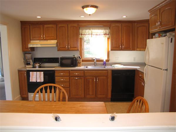 99 Moosehill Road Walpole, MA 02032 - Photo 13 of 22 a kitchen with stainless steel appliances kitchen island granite countertop a sink a stove and refrigerator