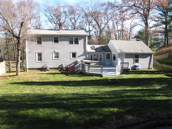 99 Moosehill Road Walpole, MA 02032 - Photo 2 of 22 a front view of a house with a garden and swimming pool