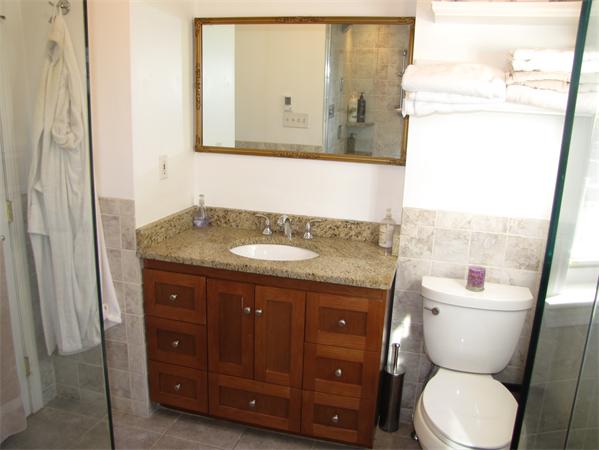 99 Moosehill Road Walpole, MA 02032 - Photo 8 of 22 a bathroom with a granite countertop toilet sink and mirror