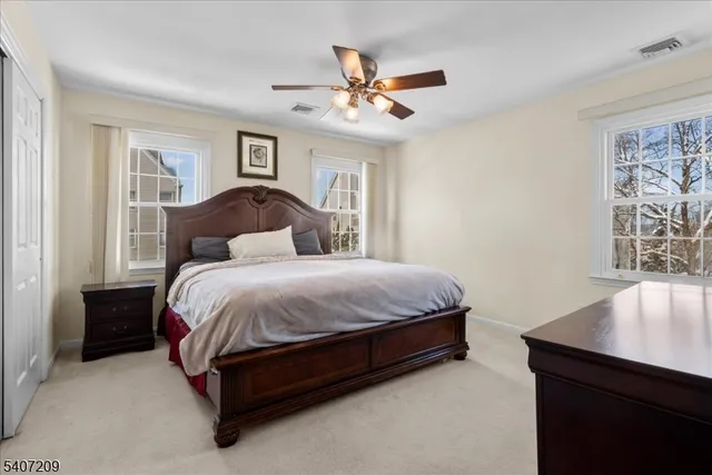 a spacious bedroom with a bed and a flat screen tv