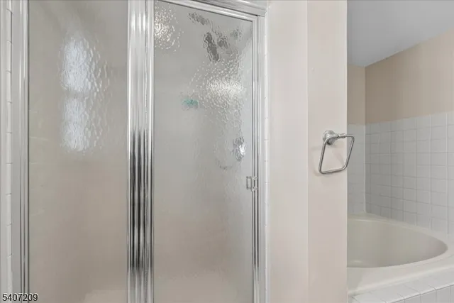 a bath tub sitting next to a white sink