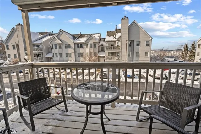 a view of a balcony with a table and chairs