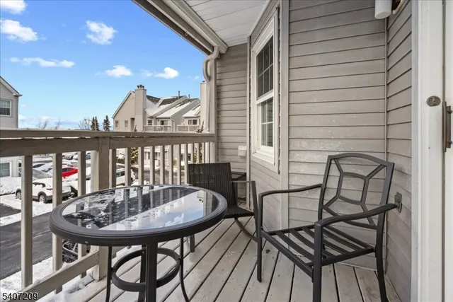 a view of a balcony with table and chairs