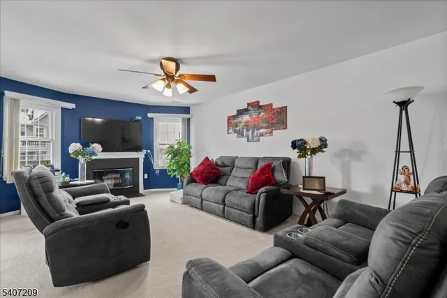 a living room with furniture a fireplace and a chandelier