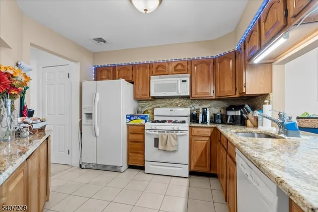a kitchen with a refrigerator and a sink