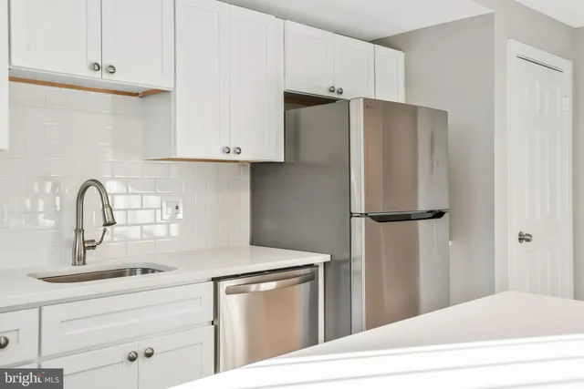 a kitchen with stainless steel appliances a refrigerator and cabinets