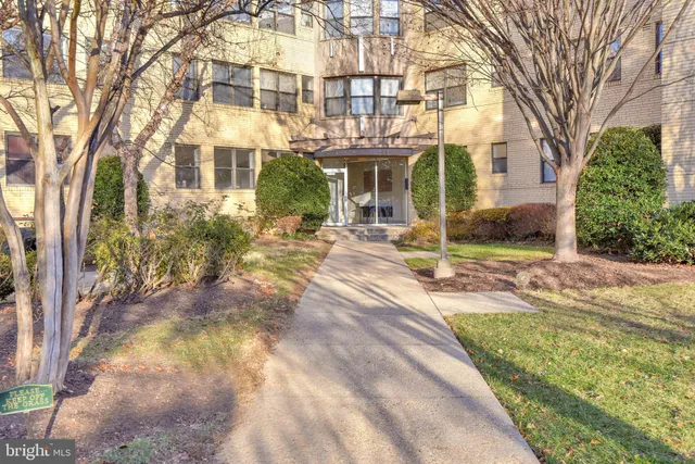 a view of a brick building next to a yard