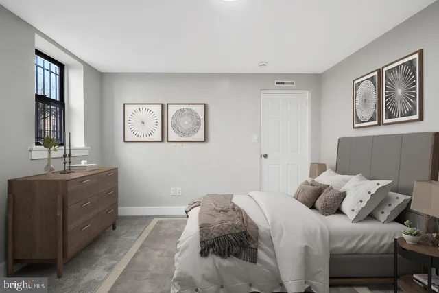 a bedroom with a large bed and a window