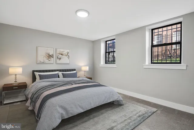 a bedroom with a bed and a window