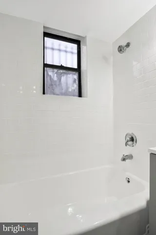 a bathroom with a bathtub and a shower