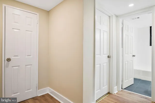a view of a hallway with wooden floor