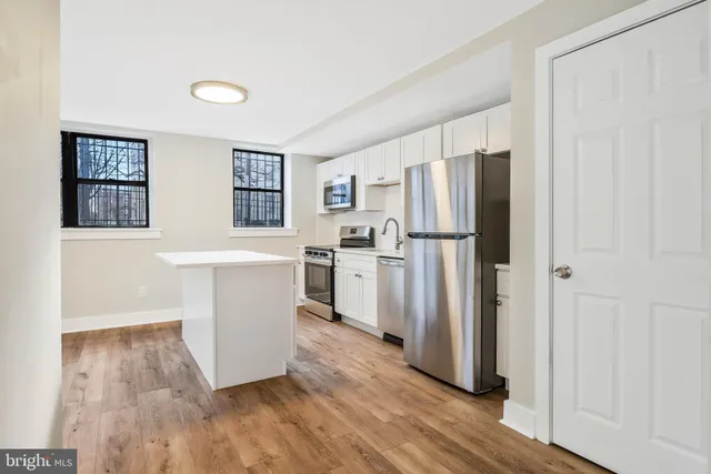 a kitchen with stainless steel appliances a refrigerator and a stove