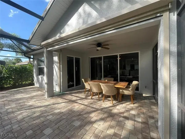 a view of a patio with table and chairs and potted plants
