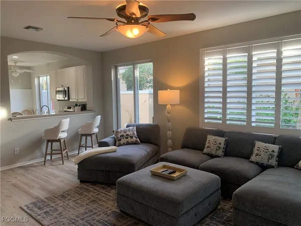 a living room with furniture and a large window