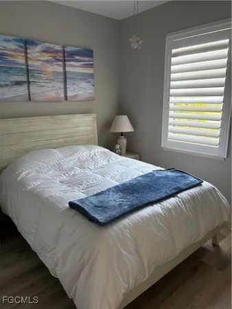 a bedroom with a bed and window