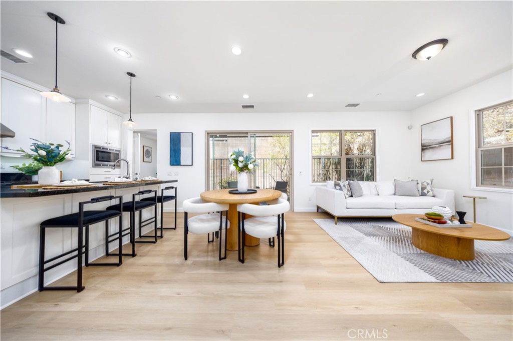 154 Firefly Irvine, CA 92618 - Photo 6 of 34 a living room with stainless steel appliances kitchen island granite countertop furniture and a wooden floor