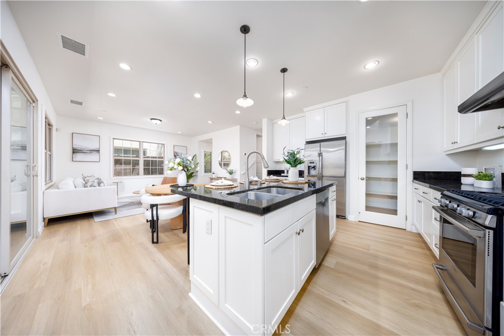 154 Firefly Irvine, CA 92618 - Photo 8 of 34 a kitchen with granite countertop a sink stove and cabinets