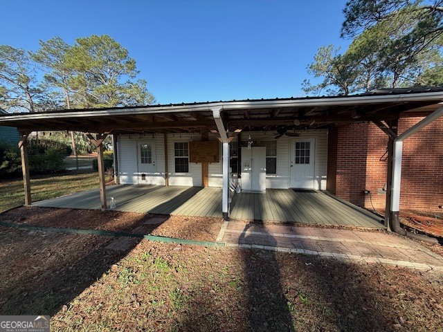 1221 Ridge Avenue North Tifton, GA 31794 - Photo 26 of 29 a view of a patio with table and chairs with wooden floor and fence