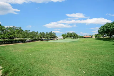 a view of a green field with clear sky