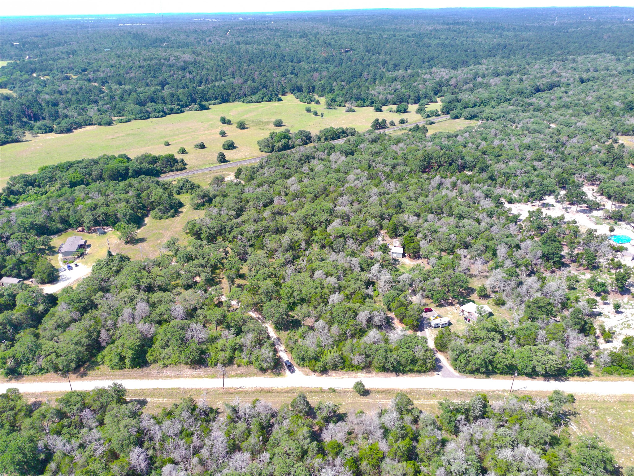 277 Meuth Cemetery Road Red Rock, TX 78662 - Photo 18 of 19 An aerial perspective reveals the expansive, heavily wooded lot with cleared areas for building.