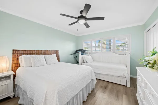 a bedroom with a bed and a ceiling fan